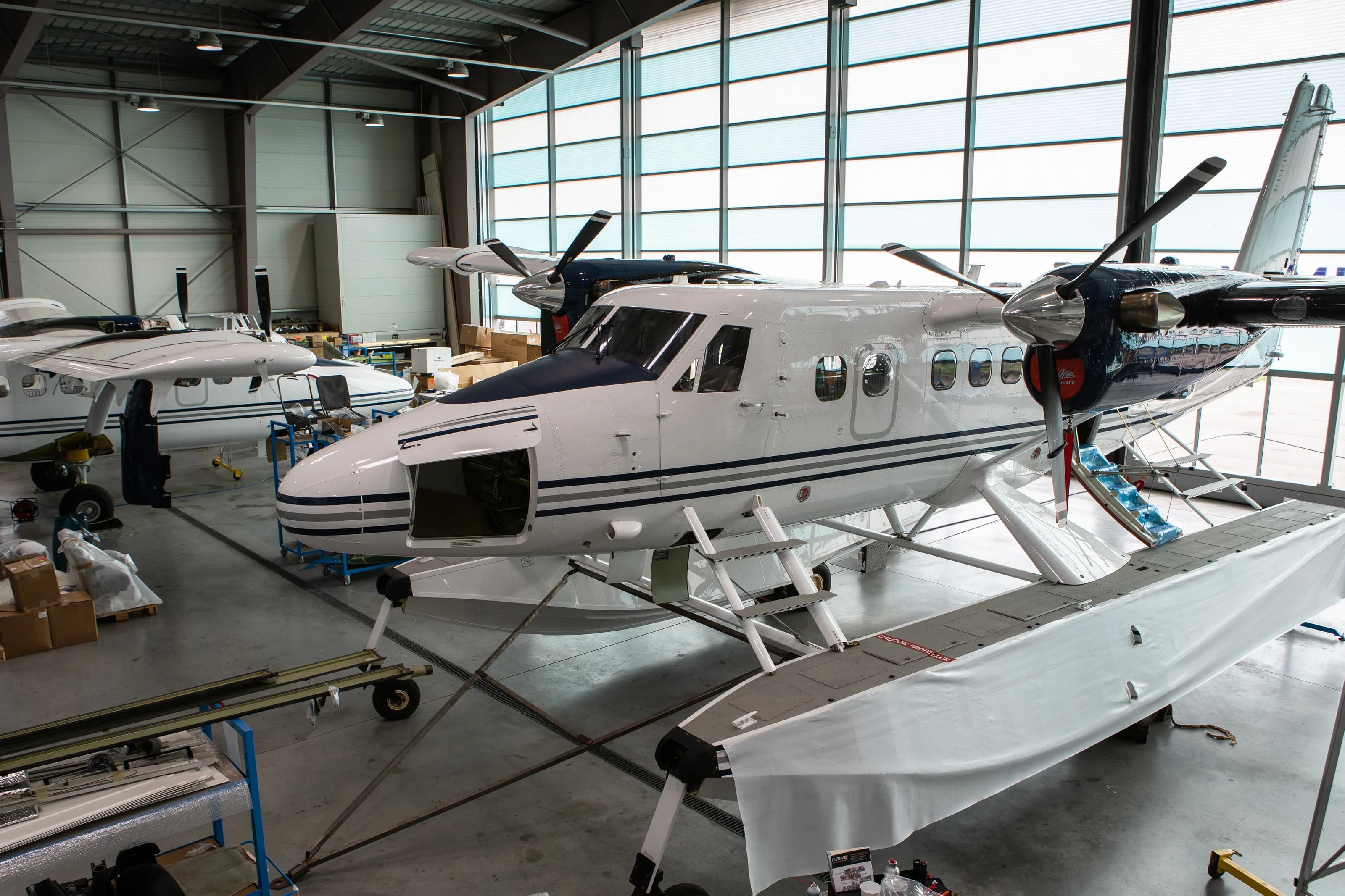 A Twin Otter on floats in the Zimex hangar at Altenrhein, under the hangar roof