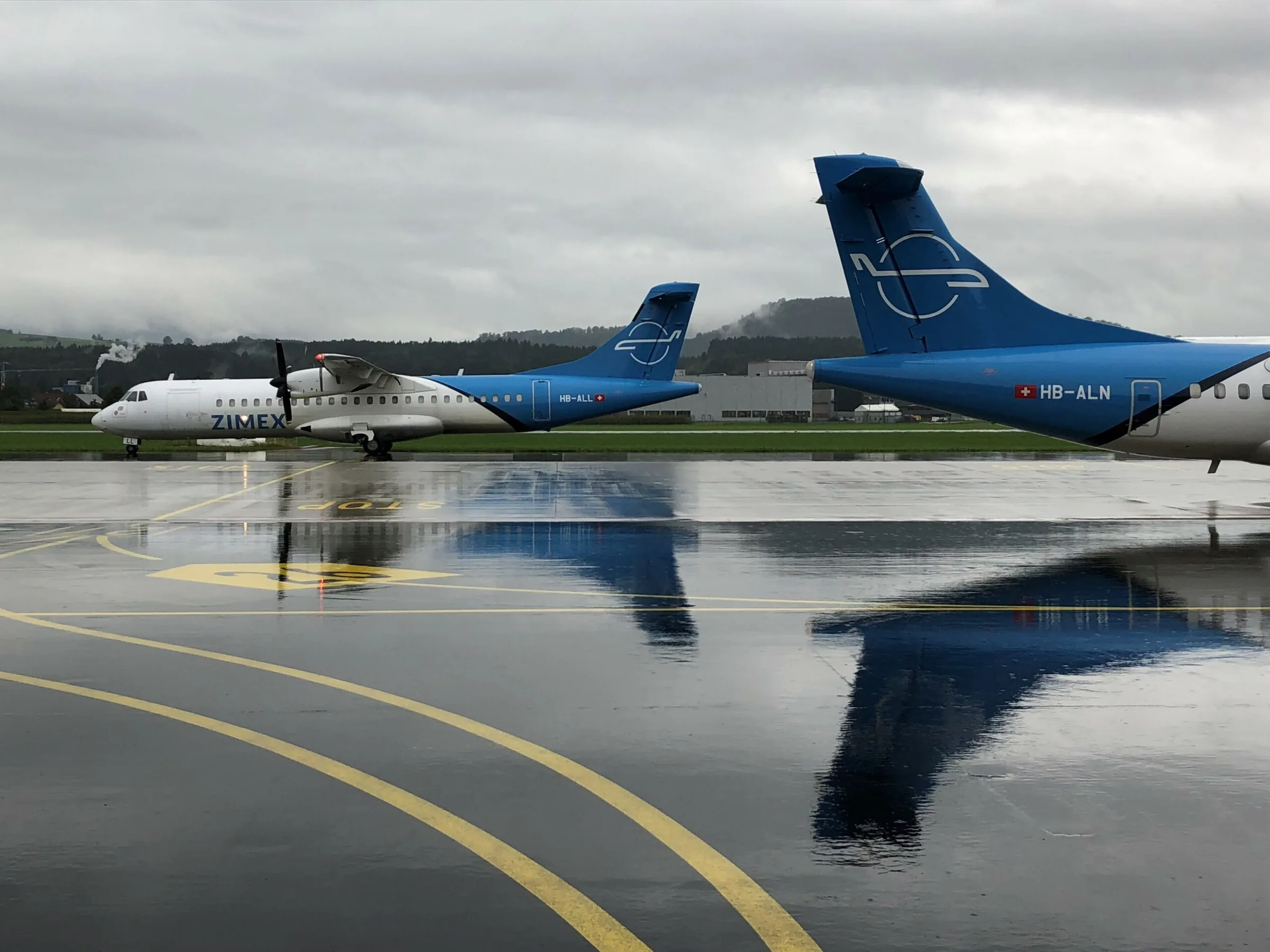 Zimex ATRs reflected on a wet apron at Emmen.